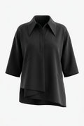 SZ black short-sleeve collared blouse with diagonal seam details and an asymmetrical draped hem, shown on a plain light gray background.