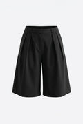SZ Black pleated wide-leg shorts with a structured waistband, shown against a plain light gray background.