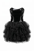 Black dress with a shiny bodice and layered tulle skirt on a white background