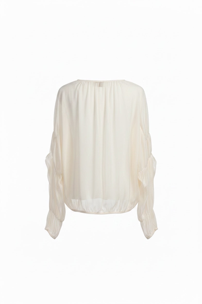 White blouse with sheer sleeves on a white background
