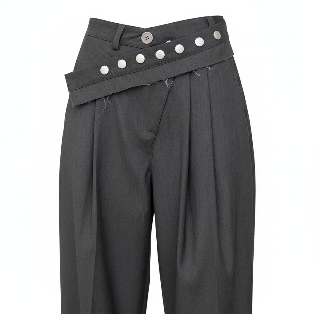 Dark gray pleated pants with button details on a white background